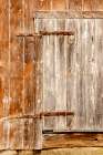 USA, New Hampshire, Troy. Old barn door with rusted strap hinges Art Print